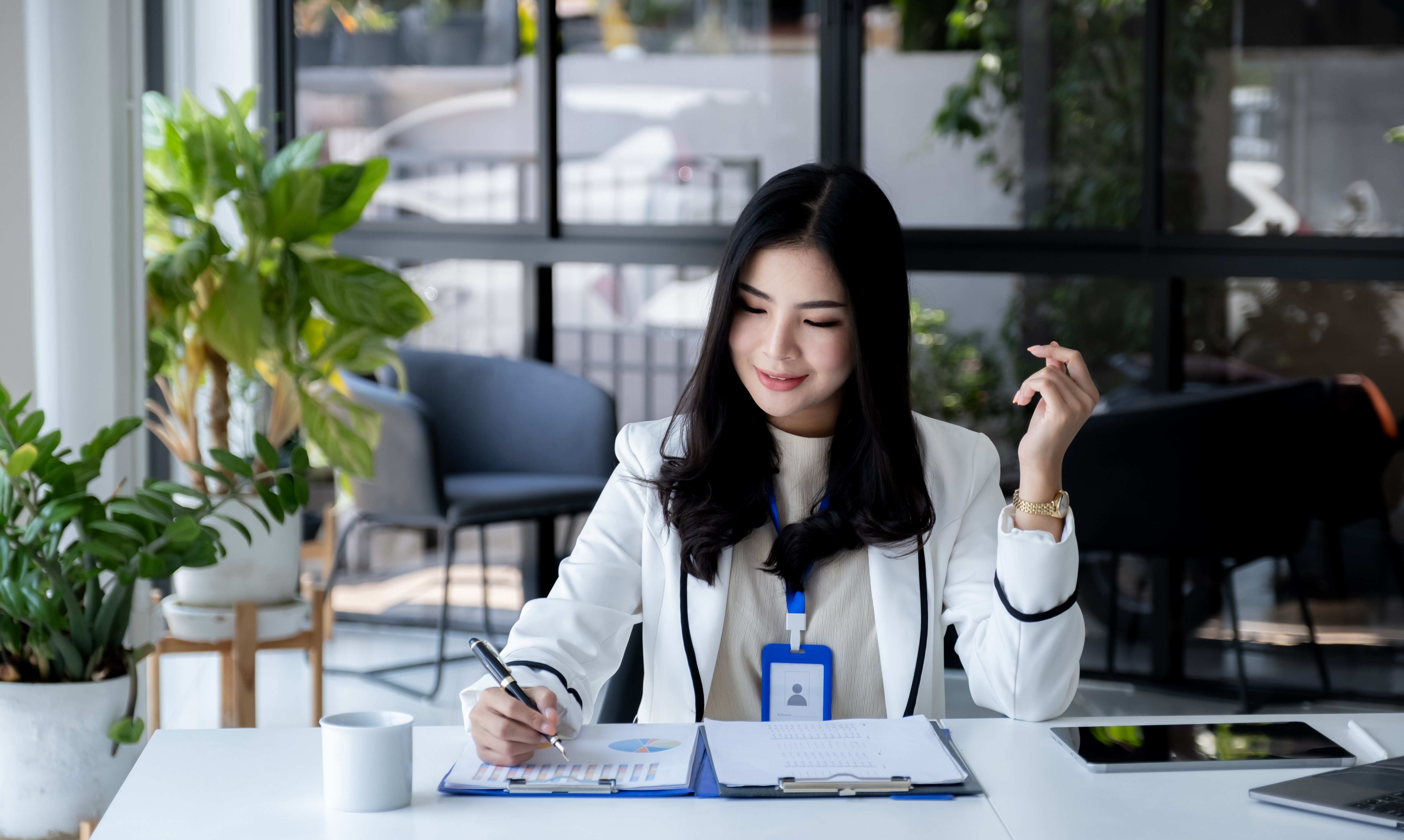 businesswomen-holding-pen-and-use-calculator-lapt-2025-02-11-19-48-16-utc