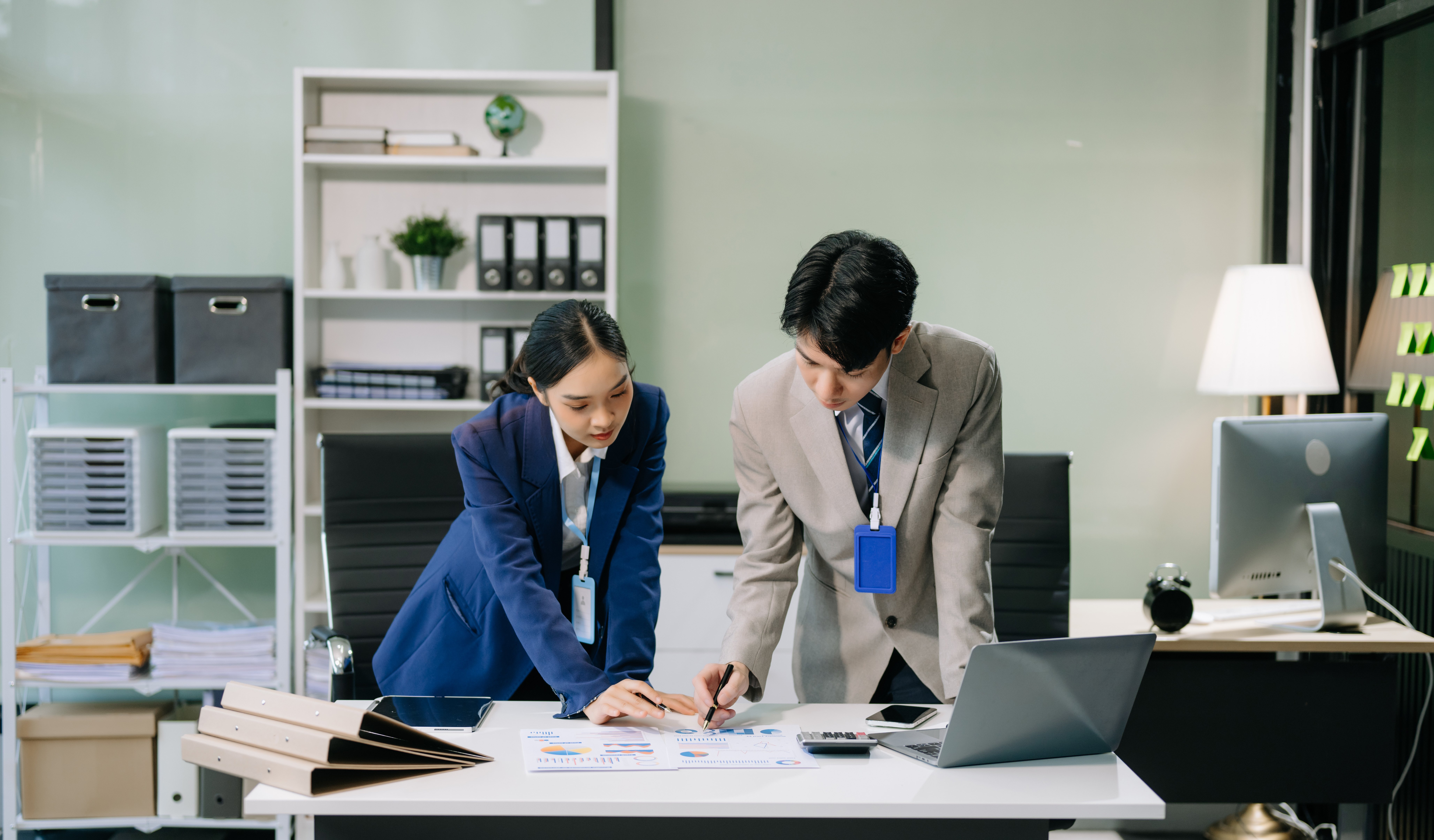 two-young-asian-professionals-engaged-in-teamwork-2024-11-02-00-28-54-utc