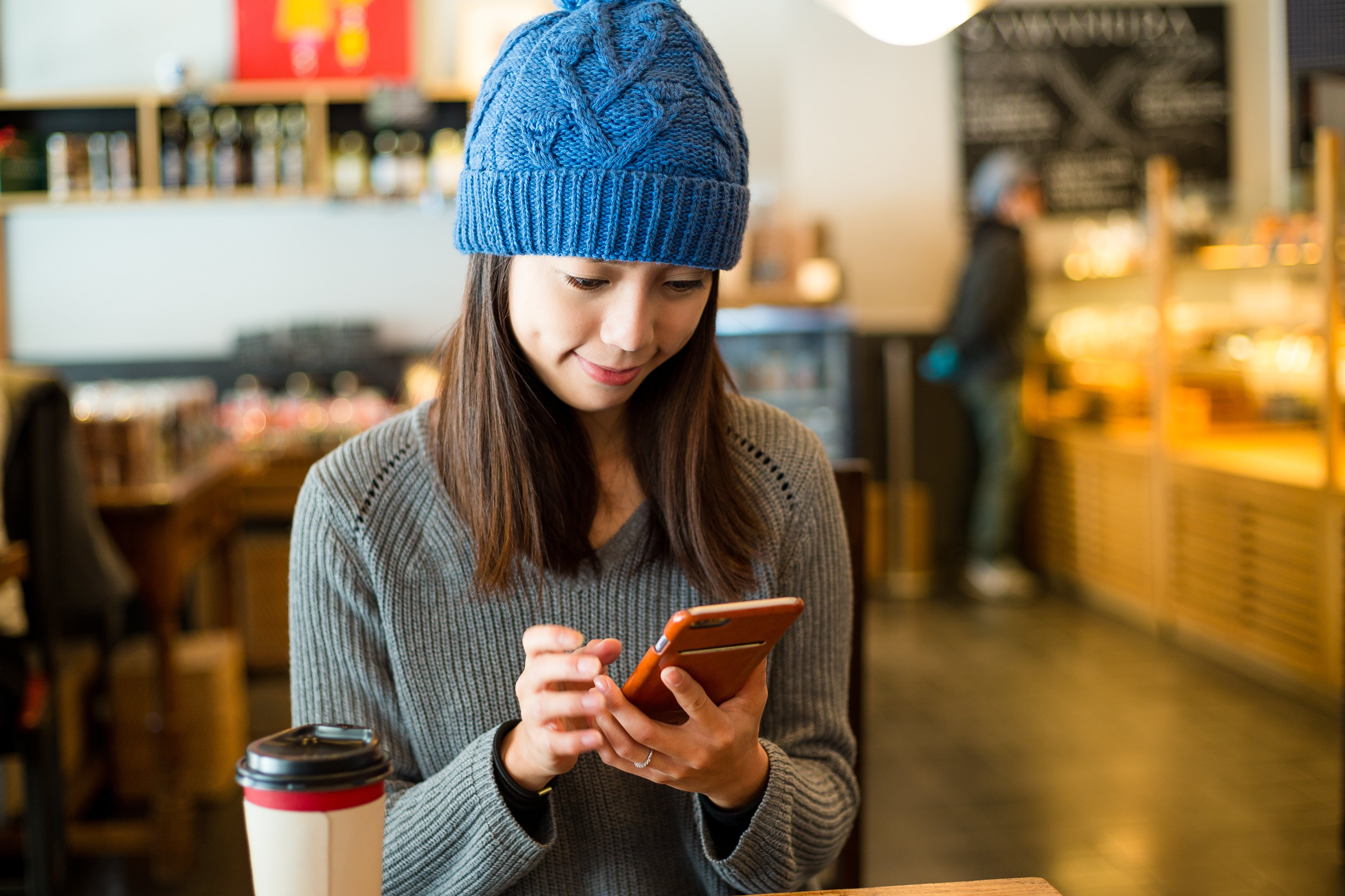 woman-use-of-mobile-phone-in-coffee-shop-at-mornin-2025-03-25-08-00-05-utc